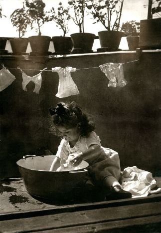 girl washing dolls clothes