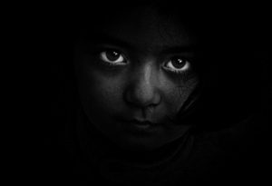 child in darkness for childhood trauma post